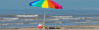 Colorful beach umbrella in the sand
