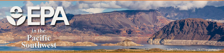 Vista of Lake Mead with blue sky, clouds, and desert mountains rising.