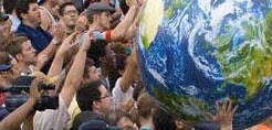 Crowd holding a large planet earth