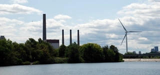 A view of the Mystic River with a power plant in the background.