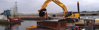 Excavating Marinette WPSC sediment from a barge