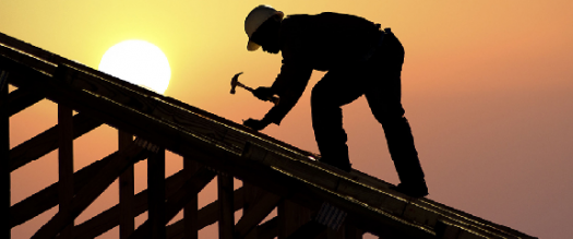 Photo of a roofer working in the sunset