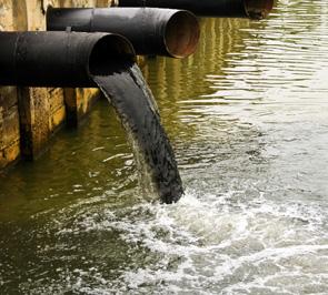 pipe flowing dirty water into a water resource