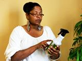 Woman reading information on a spray bottle