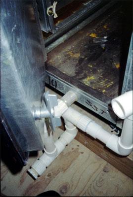 Example of a drain pan beneath a cooling coil that slopes to a drain line