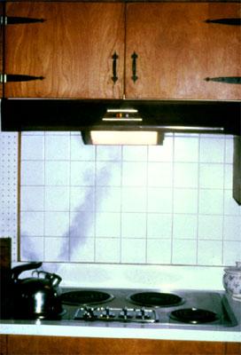 Example of an exhaust hood and fan over a stovetop in a kitchen.