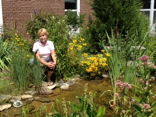 Ms. Learning sits in a beautiful garden