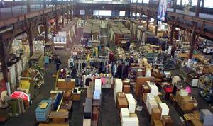Image of large open warehouse space filled with salvage.