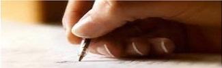 Image of a hand using a pen to write on paper