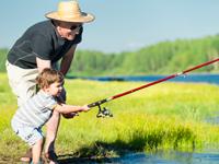 Photo: A boy fishing with adult