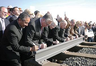 EPA Administrator Gina McCarthy, California Governor Jerry Brown and other officials signing ceremonial rail to celebrate start of construction on the high speed rail project