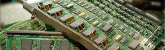 Image of a few computer mother boards stacked on top of each other