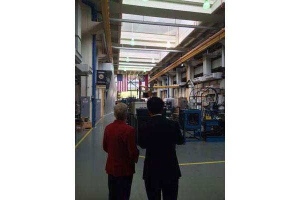 Distant shot of Administrator McCarthy in a factory.