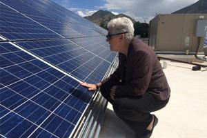 Administrator Gina McCarthy examines a solar panel in Salt Lake City