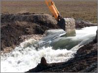 Excavator breaching the Sears Point levee.