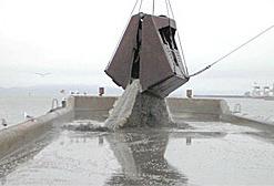 Loading a barge with dredged material.