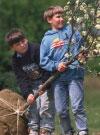 Two kids planting a tree