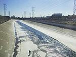Person walking beside the Los Angeles River