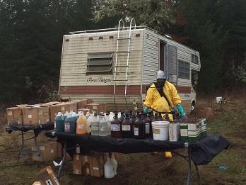 Cleanup worker removes hundres of chemical containers from an RV.