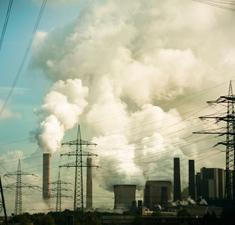 Photograph of smokestacks and power lines.