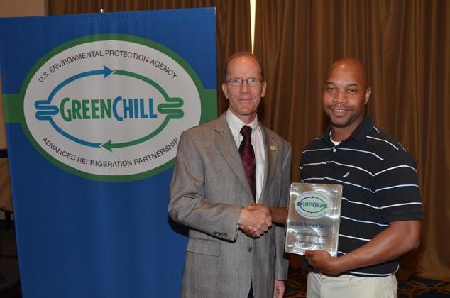 Anthony Smith of Sprouts Farmers Market accepts the Store Certification Excellence award from Tom Land of the EPA GreenChill Program.