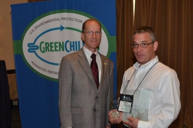 Drew Post of Dorothy Lane Market accepts Superior Goal Achievement and Most Improved Emissions Rate awards from Tom Land of the EPA GreenChill Program.