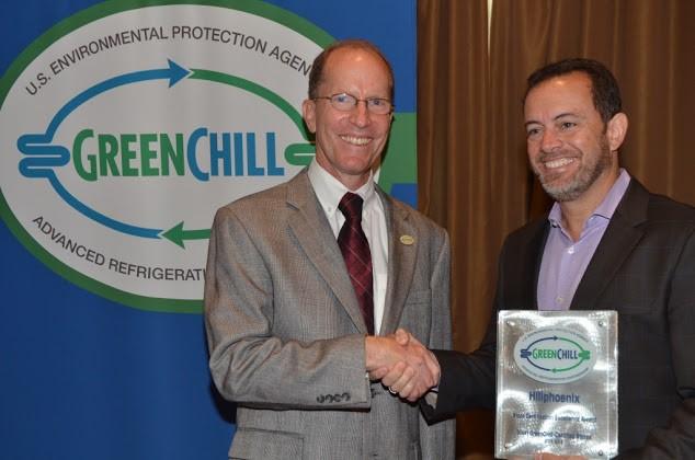 Eduardo Navarro de Andrade of Hillphoenix accepts the Store Certification Excellence award from Tom Land of the EPA GreenChill Program.
