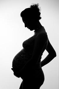 Pregnant woman's silhouette against grey background