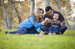Happy young family playing in a park
