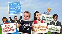 People holding signs: ENERGY STAR, Be an ENERGY super hero, Thank you, Making a difference, Saving money, Saving the planet