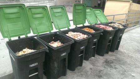 Photo of a line of garbage bins with wasted food in them at Orange County Sheriff's Department