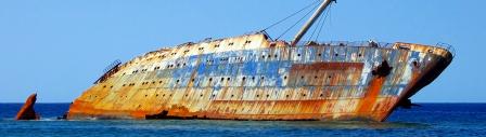 Image of an abandoned, rusted, derelict vessel