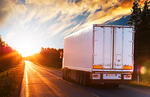 Trucks driving in the sunset