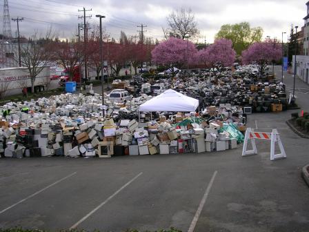 This image is of a parking lot filled with electronics--especially monitors with cathode ray tube  that were collected for recycling in 2008. Thousands of electronics are shown in the photograph.   