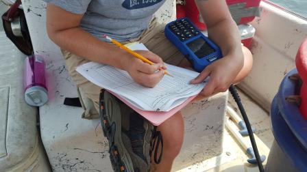 NCCA field crew member recording data during a site visit