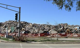 Large piles of cleanup debris from Hurricane Katrina.