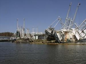 Photograph of damaged fishing boats at a port after Hurricane Katrina.