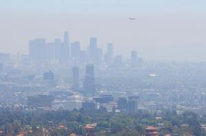 Photograph of smog above an urban landscape.