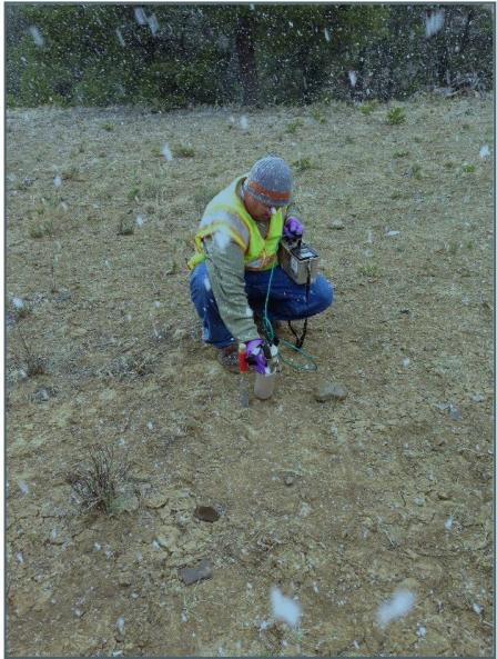 A technician measures radiation in the ground at Ruby #1