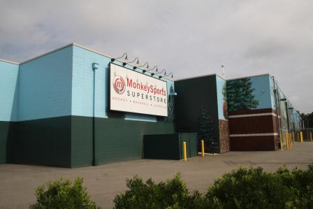 The Monkey Sports Superstore is located adjacent to the capped area, which is covered with asphalt and used as a parking lot.