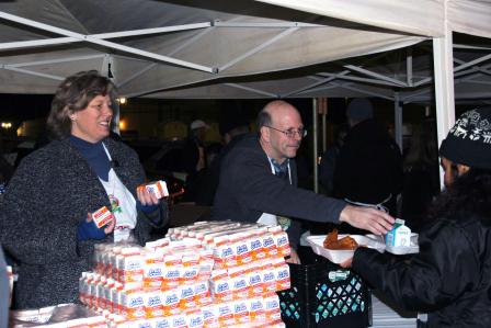 Two EPA employees passing out milk cartons.