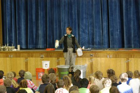 this is a picture of a NERC official demonstrating waste sorting at a school in VT