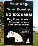 Sign directing pet owners to properly dispose of their pet's waste.