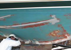 Applying alternative paints on bottom of boat.