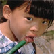 Girl drinking clean water from a hose