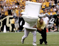 Photo of a man in a toilet costume being tackled
